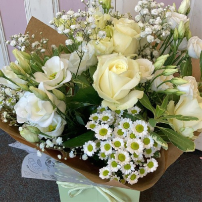 Classic - An stunning handtied in water presented in a gift box. Using all white flowers with complimentary foliage. Hand delivered with care in and around Dereham by Bright and Beautiful.
